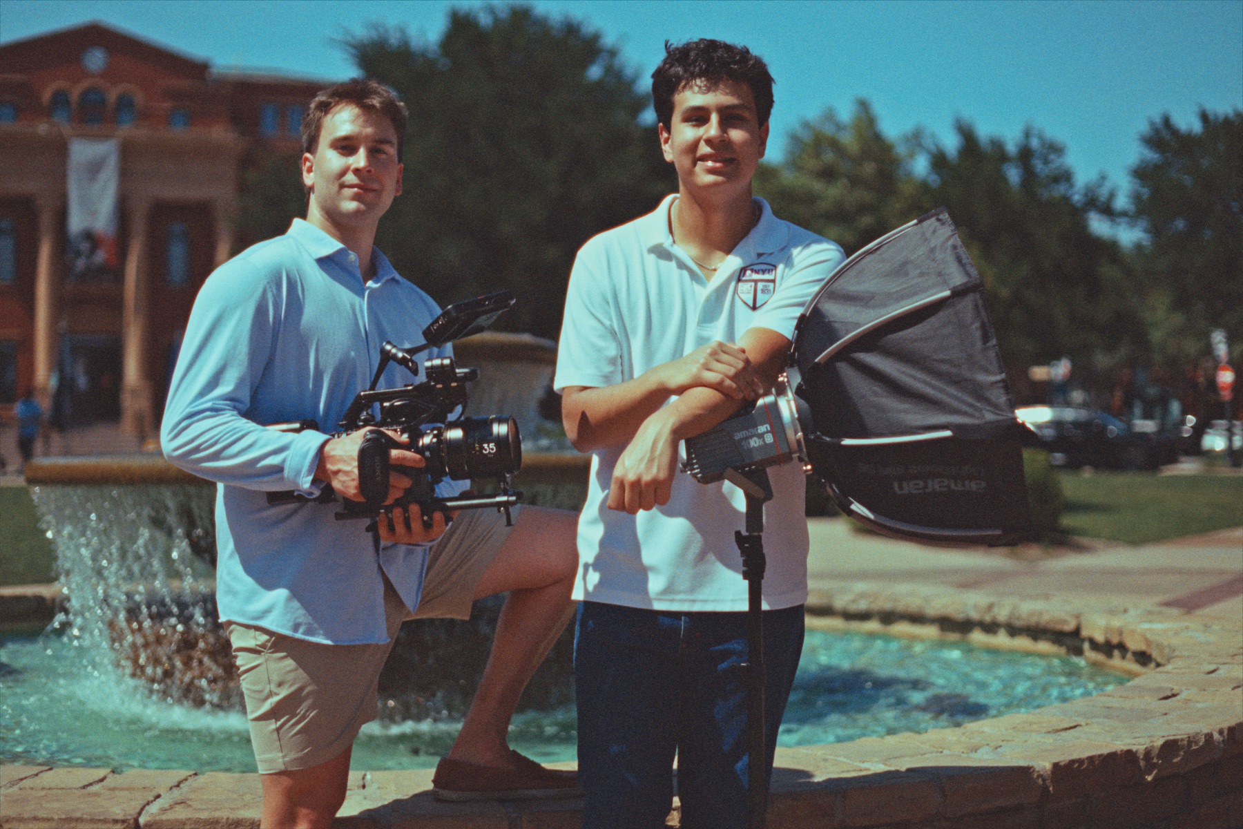 Graham Davidson and Dylan Spiegelman with video equipment near a fountain